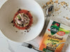 Mix di cereali e legumi, calamari, succo di pomodoro, basilico e polvere di olive 